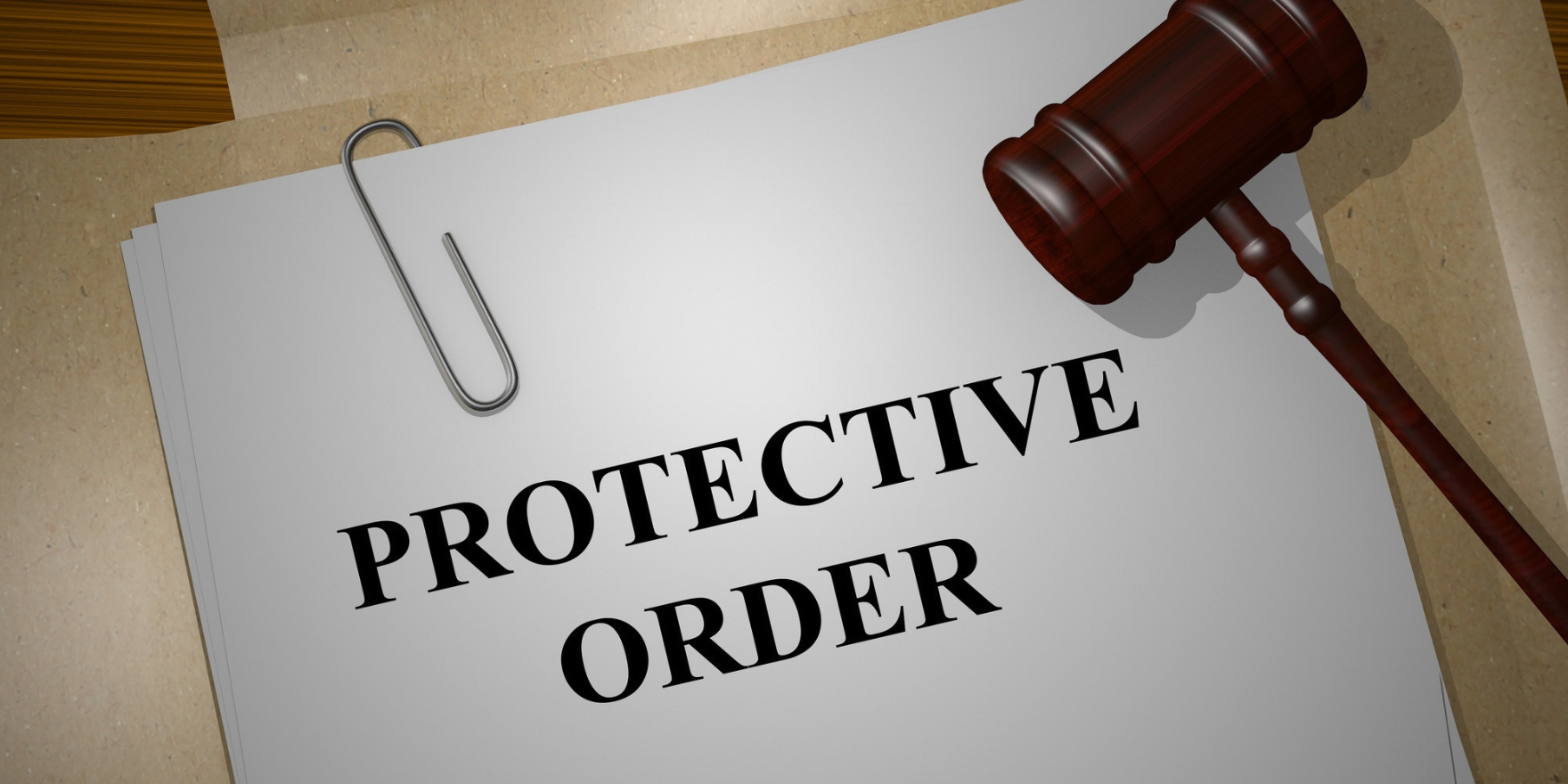 A document titled “Protective Order” on a stack of legal folders, with a wooden judge’s gavel resting beside it.